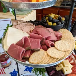 Charcuterie Board with Meats, Cheeses, Olives, and Crackers